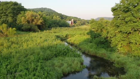 rural landscape with red barn and river