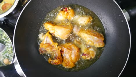 chicken meat cut into small pieces and put into the hot pan. it is fried using hot cooking oil until cooked and crunchy.
