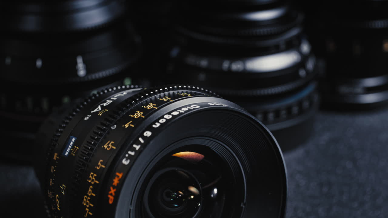 A Packshot of an expensive cinema lens in front of other cinema lenses.