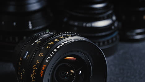 a packshot of an expensive cinema lens in front of other cinema lenses.