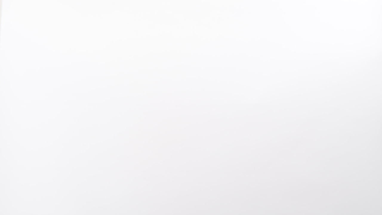 Close up of Woman's hand receiving a parcel cardboard box from a delivery man who gives her a postal package box isolated on a white studio background. Shipping and Delivery concept.