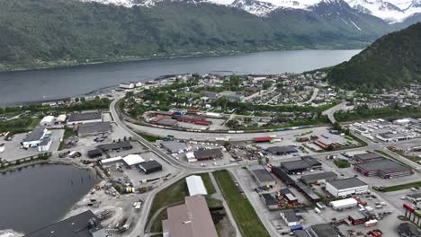 andalsnes city center aerial - springtime high angle looking down at buildings and scenery in rauma