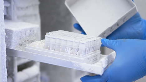 scientist opening test tube box from freezer 4k