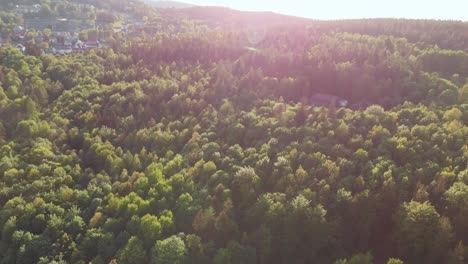 aerial orbit over the famous izerskie mountain bike trail village with stunning lens flare