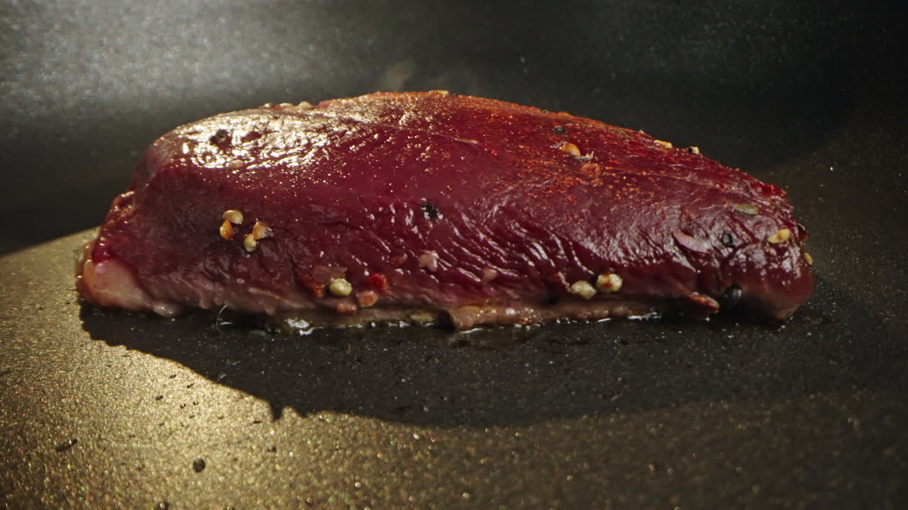 Steak cooking in a pan
