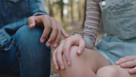 teenage couple holding hands boyfriend and girlfriend sharing romantic connection sitting in forest woods concept