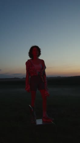 woman in field at sunset