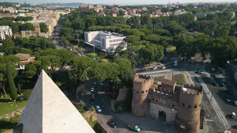 Drone-Flies-Over-Ostiense-Square,-Pyramid-of-Cestius,-Porta-San-Paolo