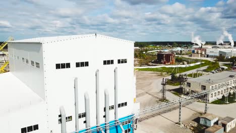 industrial building complex with storage tanks and pipes