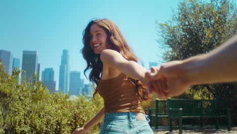 Happy-woman-holding-boyfriends-hand-going-at-park.-Asian-girl-leading-friend.