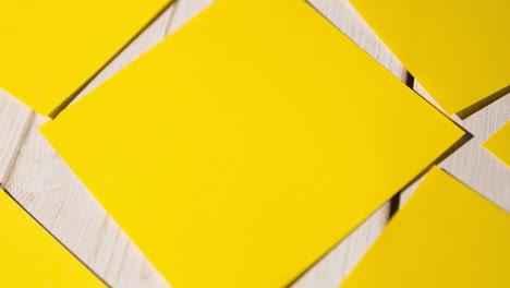 animation of multiple yellow cards lying on wooden table