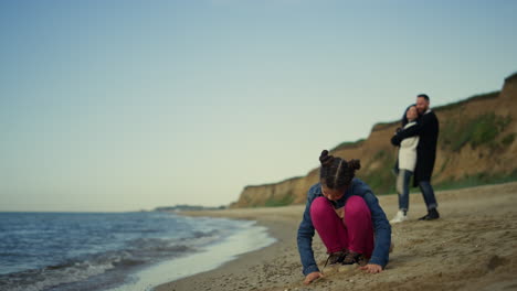 pasando tiempo en familia en la playa en vacaciones en el mar. niña pequeña jugando en la arena en el océano.