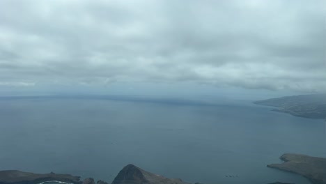 a pilot’s perspective overflying ponta delagada during the approach to funchal airport in a windy winter morning