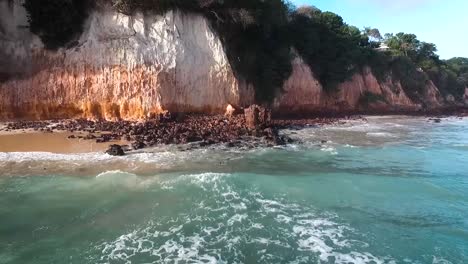 aerial view of a stunning beach with red cliffs