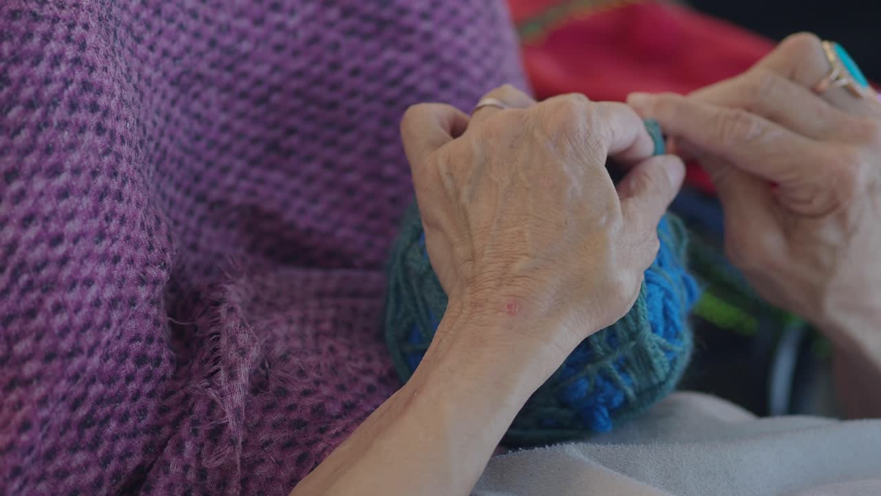 Close-up of Hands Knitting with Yarn