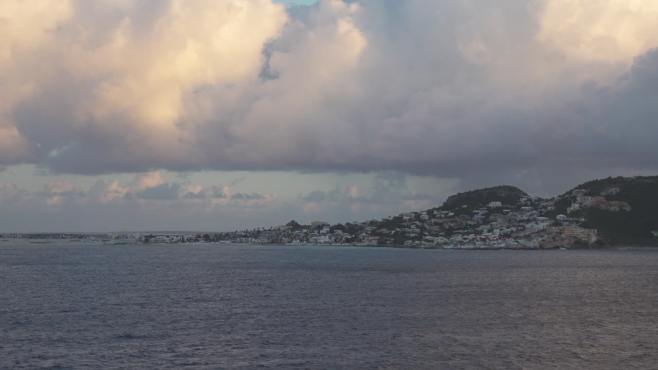 View of Sint Maarten coastal town recorded from a passing cruise ship's balcony on its way to dock at Philipsburg