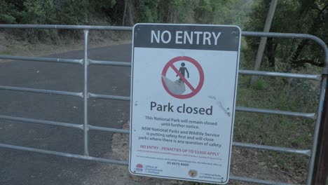 no entry signage on the entrance gate of wollumbin national park - no entry, park closed due to pandemic in tweed range, nsw, australia