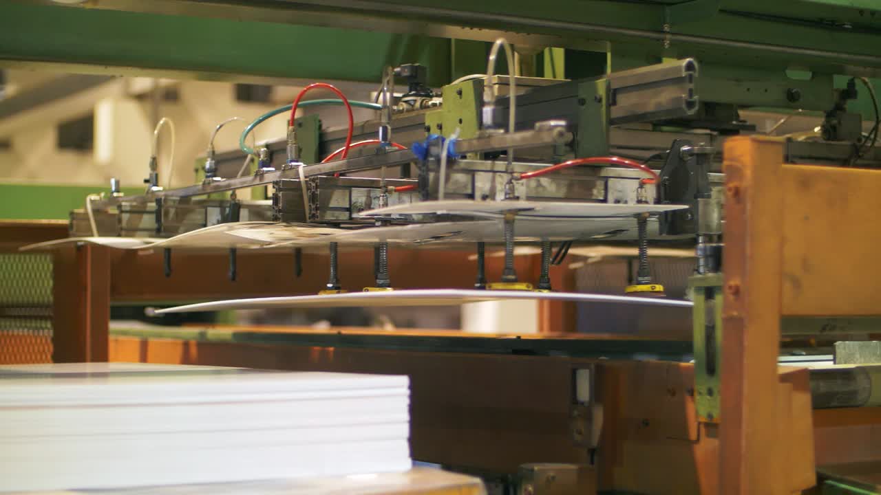 Automatic manipulator holding plastic sheet. Production plastic detail at plant