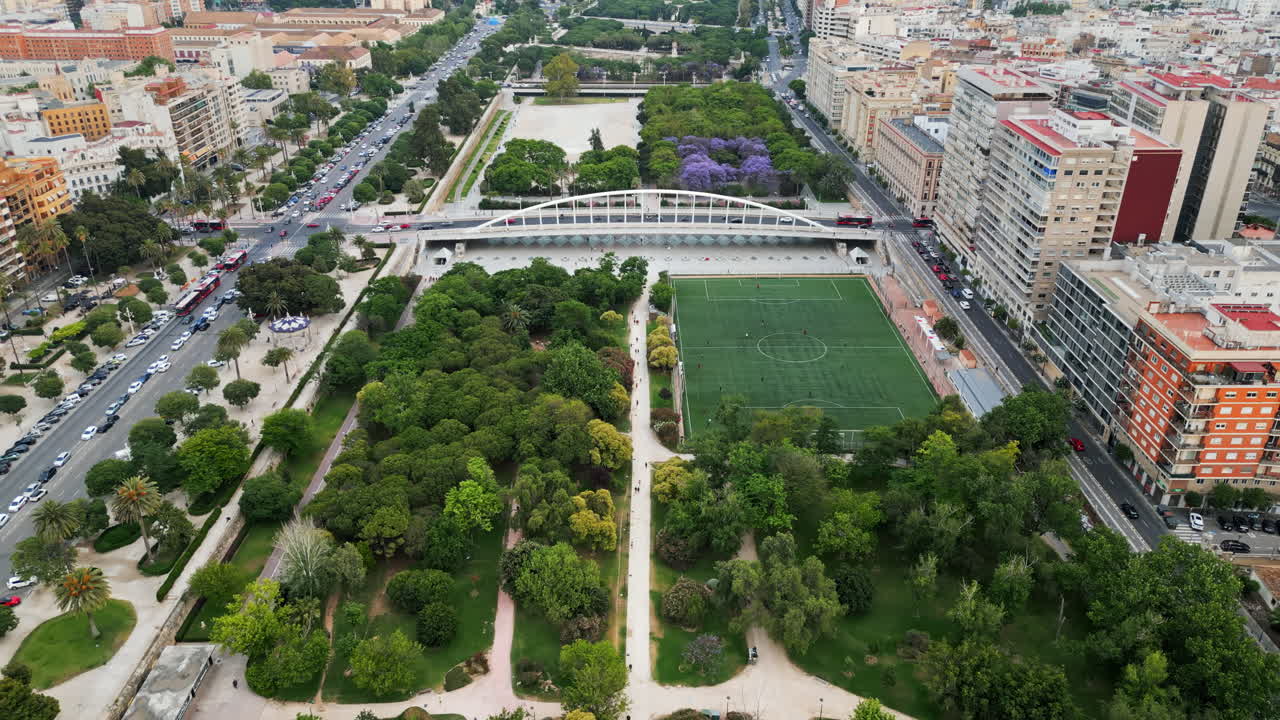 Cars and public transportation moving on the Exhibition Bridge near the Mestalla Stadium, and the Turia Gardens Park in Valencia, Spain