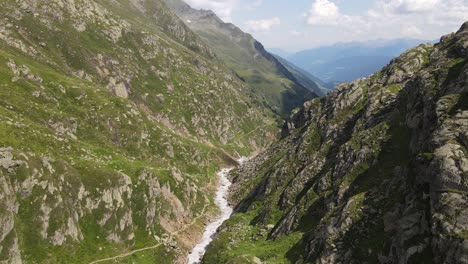 wide-angle-drone-video-of-the-beautiful-mountains-in-northern-Italy-with-a-giant-waterfall-and-river