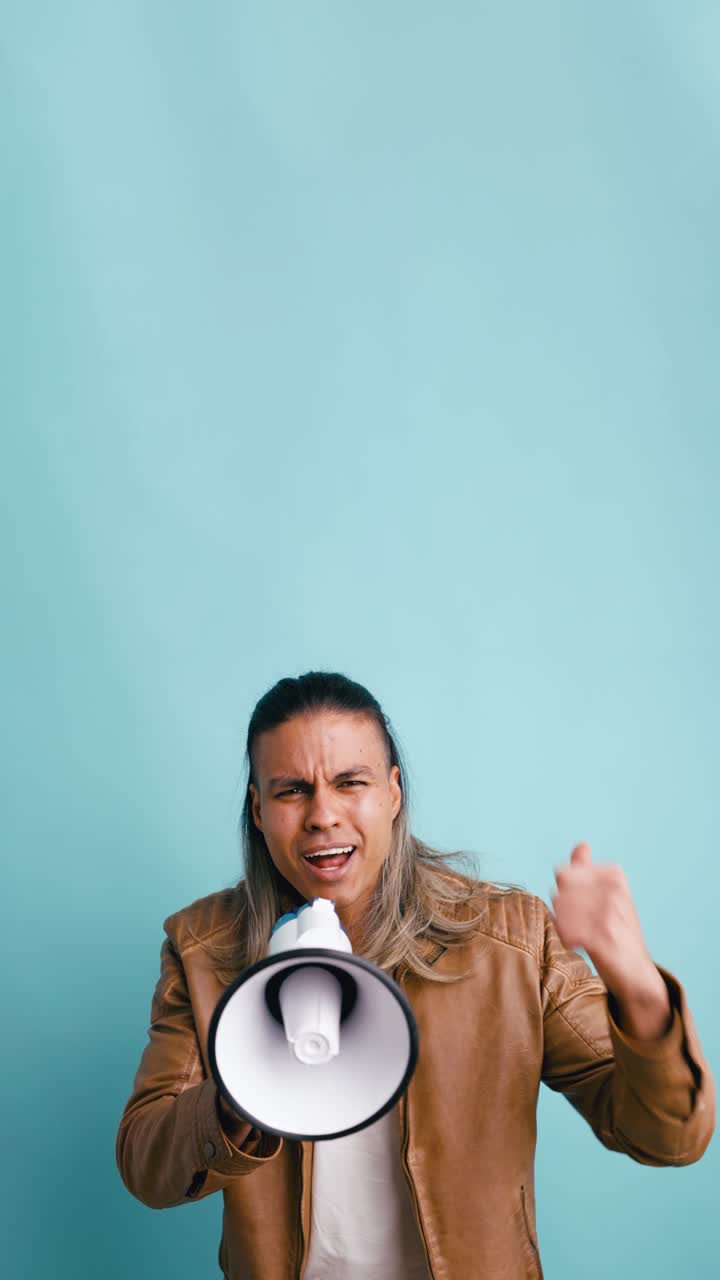 Expressive Man Shouting and Smiling with a Megaphone