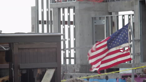 a tattered american flag waves in the wind after hurricane sandy batters the brooklyn beachfront