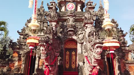 traditional door pyramidal architecture of bali indonesia ardha candra stage in denpasar with penjors hanging