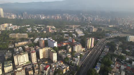 caracas city with highway and ucv campus, surrounded by greenery, aerial view