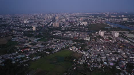 suburb of ho chi minh city, vietnam with rice field, residential area and urban sprawl as seen from aerial view on sunny afternoon