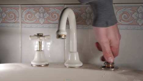 handyman replaces tap headgear and washer on household faucet