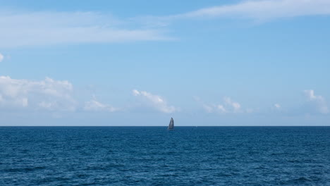 sail boat at the horizon in the sea