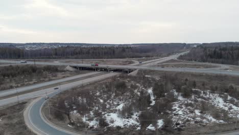 a car interchange with an overpass on a cloudy spring evening in the woods