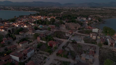 Aerial-view-flying-over-Side-old-town-Turkish-neighbourhood-homes-and-development-real-estate-at-sunset