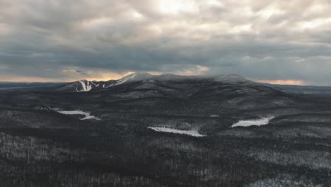 Cloudy-Sky-During-Sunset-In-Snow-Covered-Forest-Mountains-In-Orford,-Canada
