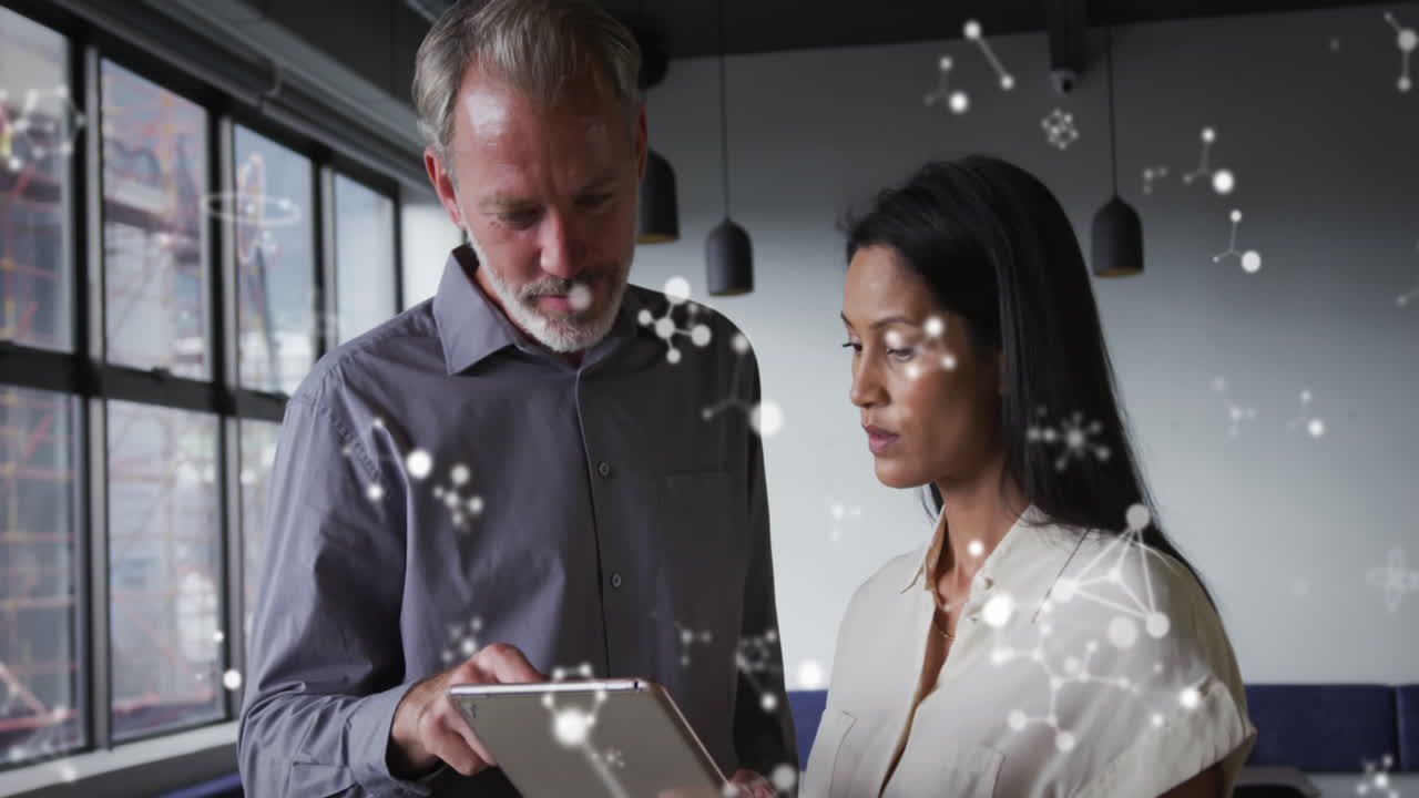 Animation of molecular structures floating against diverse man and woman discussing at office