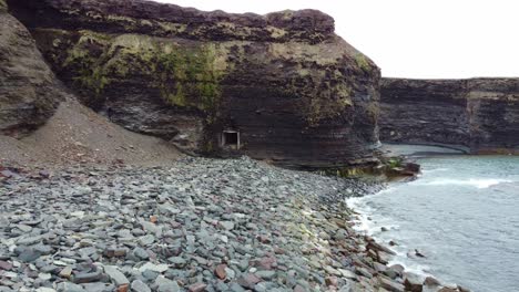 approaching an abandonned mine on the coast with a hidden beach in the background