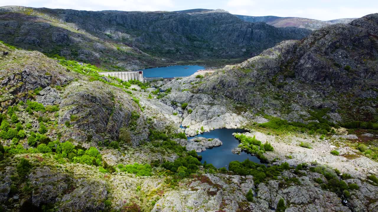 Aerial dolly push in to incredible dam lake and river winding across rocky tera canyon zamora spain landscape, drone