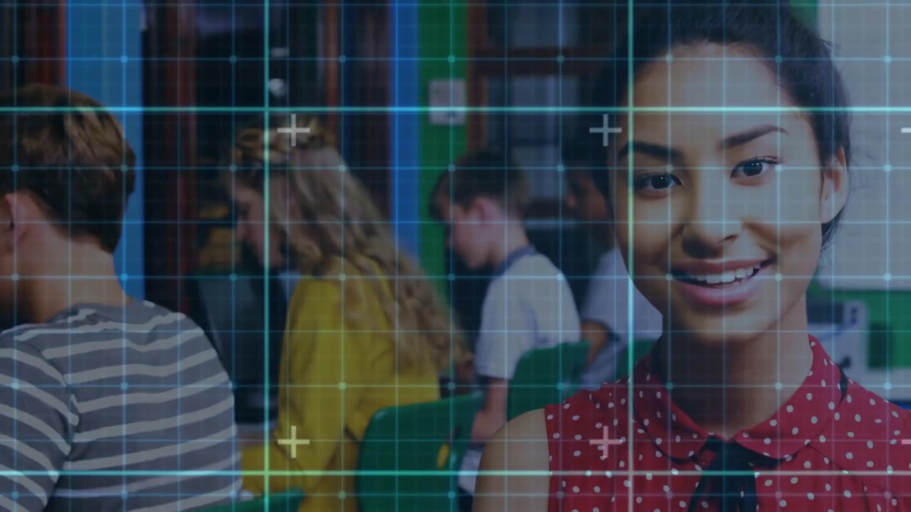 Student viewing tablet and raising head smiling for class demo while grid overlay syncing tablet