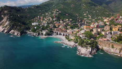 an italian coastal town with buildings and mediterranean coastline, aerial view