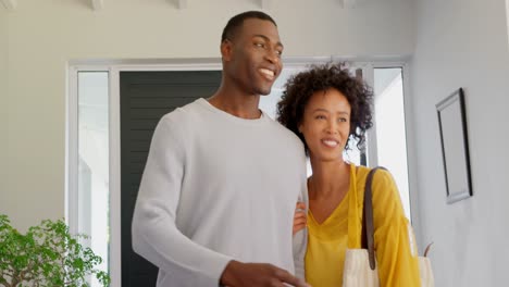 front view of happy black couple standing in their new house 4k