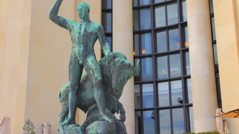 statue of hercules taming a bison positioned on trocadero left wing in paris, france