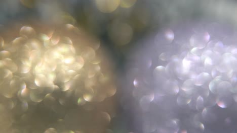 high resolution colorful crystal ornaments blurry particles, illuminated glowing lights, fuzzy glare elements 360 rotating, christmas decoration, commercial slow cinematic macro zoom out shot 4k video