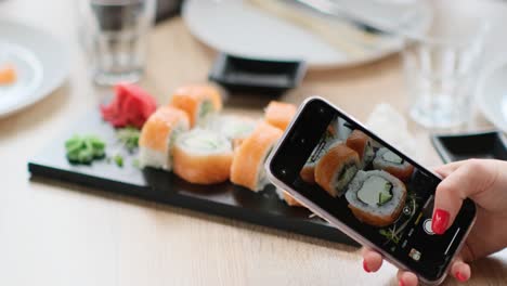 taking pictures of sushi on the phonefish