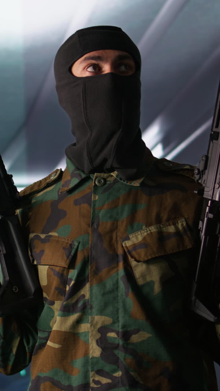 Vertical video Rebel forces insurgent with weapons in hidden base
