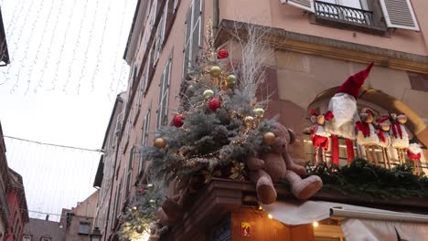 Christmas-tree-and-teddy-bear-decoration-on-storefront-in-the-streets-of-Strasbourg,-France-at-a-Festive-Christmas-market-in-Europe