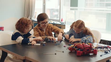 children engaged in a robotics and electronics stem project