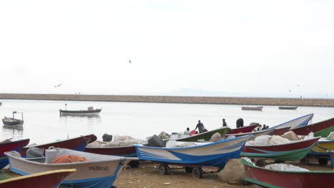 row of small fishing boats resting on beach in gwadar, pakistan