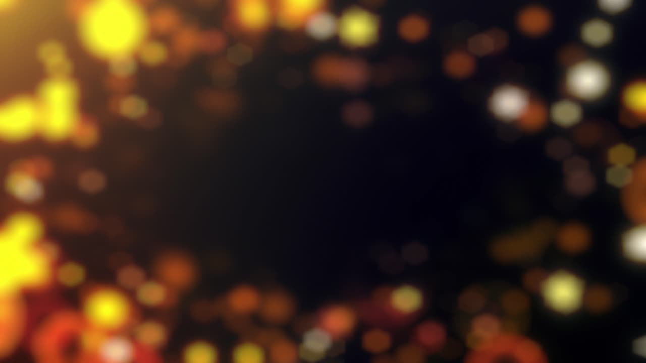 bokeh cálido, brillante y burbujeante aparece y desaparece en un fondo oscuro, en una animación en bucle