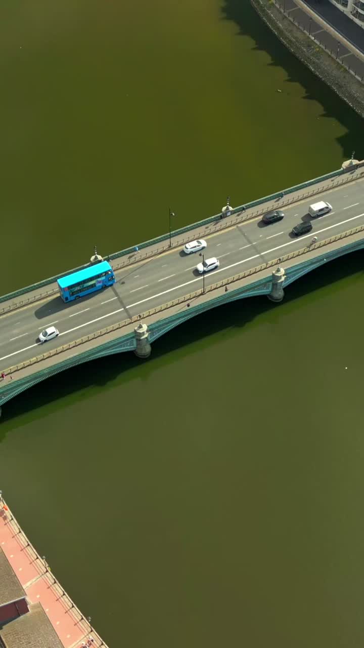 Passing overhead social ratio aerial video of Queen’s Bridge in Belfast, County Antrim, Northern Ireland, UK on a sunny day. Produced in 1080x1920 vertical ratio, 60FPS and with Rec709 color
