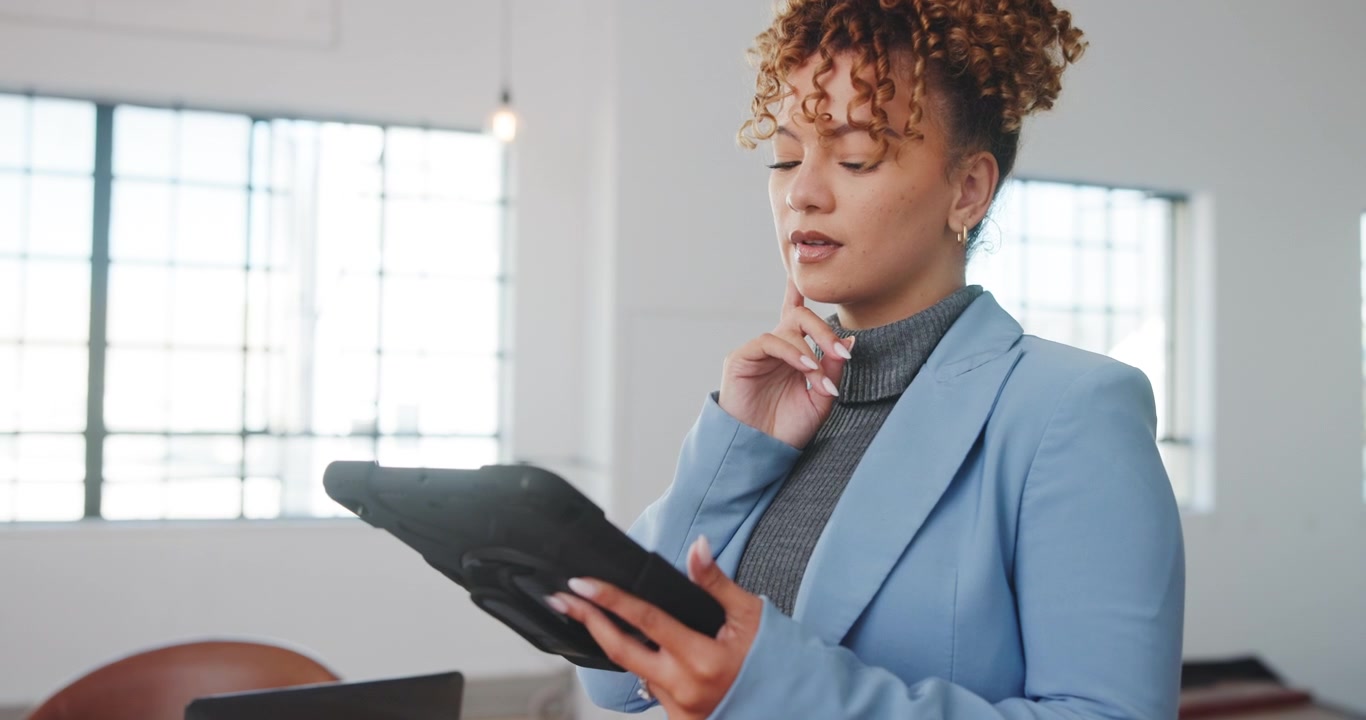 Professional Woman Using Tablet in Modern Office